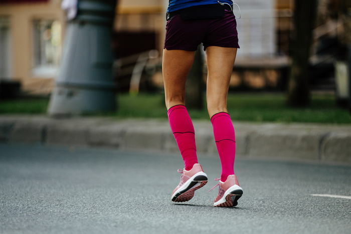 back women feet in pink compression socks