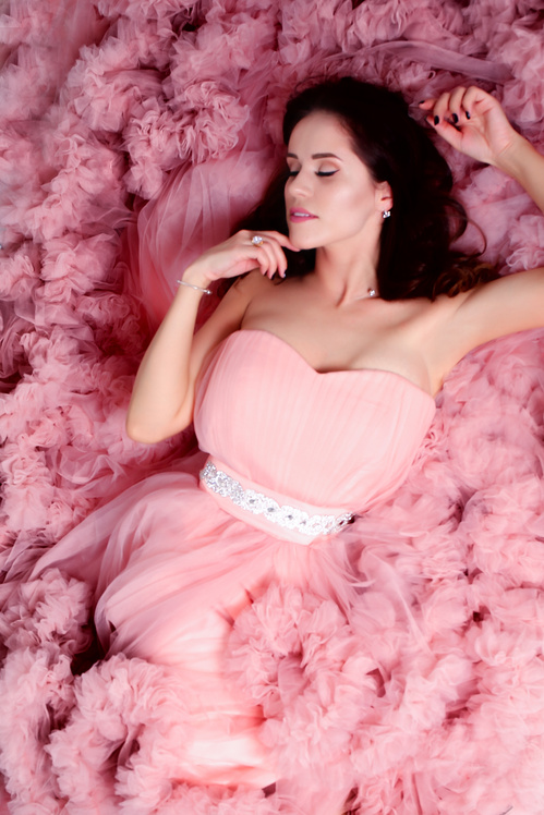 Lying Woman Wearing Pink Sweetheart Neckline Dress